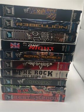 WWE VHS Collection Stack – Black, Red, Blue, Gold Spines